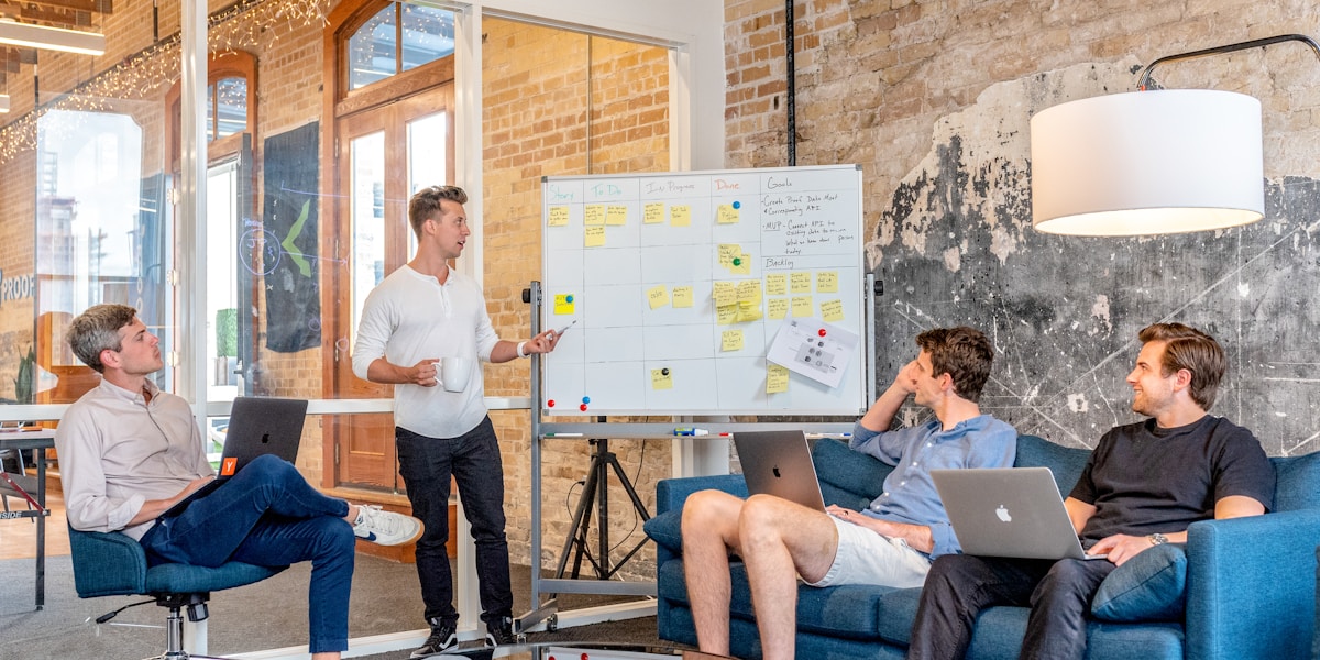 A diverse team of professionals looking at a presentation with charts and data.