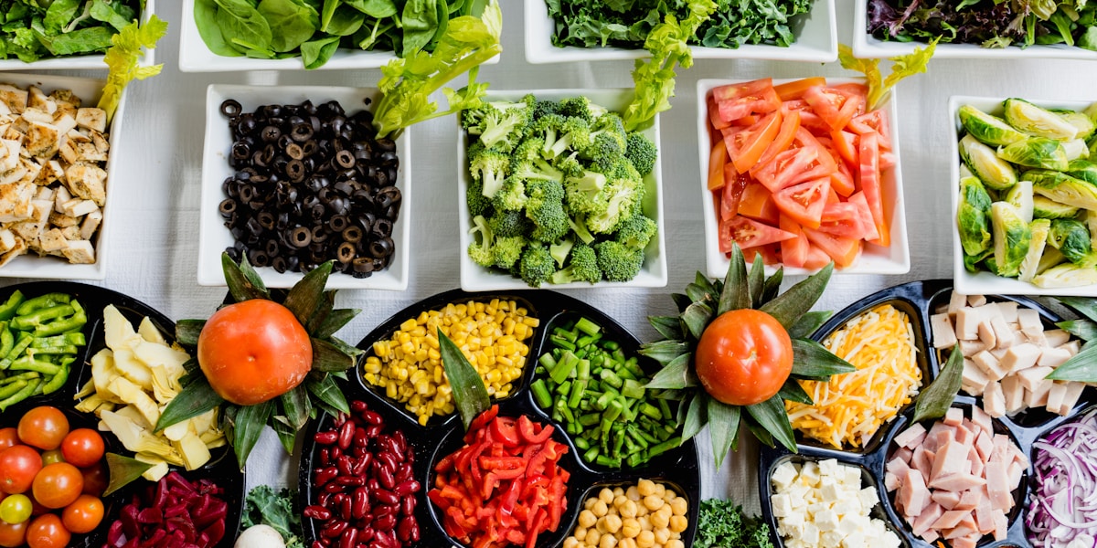 A variety of colorful, fresh fruits and vegetables spread out on a table.